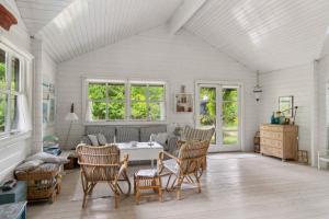 a living room with a table and chairs at Charming House Near Private Beach And Nature in Rørvig