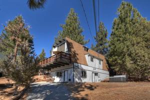 a large white house with a roof at Yosemite Pines Cabin - Sleeps 6 in Big Bear Lake