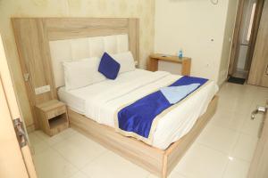 Postel nebo postele na pokoji v ubytování Hotel Aman Inn