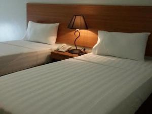 Postel nebo postele na pokoji v ubytování Mango Suites - Isabela