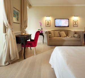 a living room with a couch and a table at Hotel Riviera & Maximilian's in Trieste