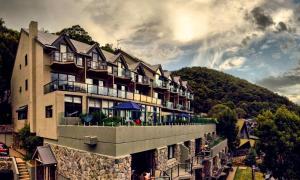 a large building on a hill with a mountain at Lantern 28 - Loft in Thredbo