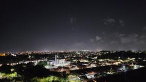 a view of a city at night with lights at Suítes e quartos in São Luís