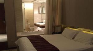 a bedroom with a bed and a bathroom with a window at Nanjing YuTimes Hotel in Nanjing +146 photos