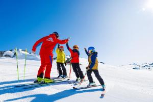 a group of people on skis in the snow at Lantern 13 - Deluxe Terrace in Thredbo