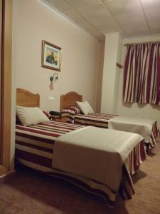 Łóżko lub łóżka w pokoju w obiekcie Hotel Mesón el Castillo