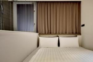 Postelja oz. postelje v sobi nastanitve Wonstar Hotel