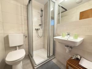 a bathroom with a toilet and a sink and a shower at Appartement Albert und Helene Koller in Söll