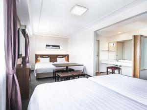 Postel nebo postele na pokoji v ubytování Hotel New Hankyu Osaka Annex