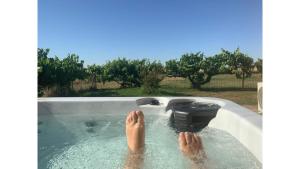 a person with their feet in a bath tub at Starry Night Farmstay by Tiny Away in Forbes