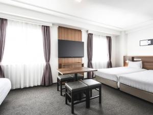 Postel nebo postele na pokoji v ubytování Hotel New Hankyu Osaka Annex