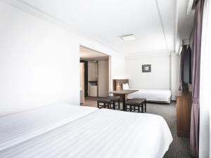 Postel nebo postele na pokoji v ubytování Hotel New Hankyu Osaka Annex