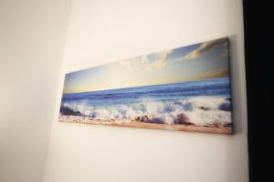 a painting of the ocean on a wall at Il Faro Trapani b&b Rooms & apartments in Trapani
