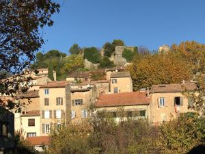 a group of buildings on a hill with trees at Var Village House in Salernes