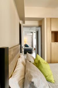 a bedroom with a bed with pillows on it at FantaSea Apartment in Vlikhon