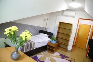 Postel nebo postele na pokoji v ubytování Auguszta Hotel