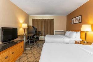 a hotel room with two beds and a flat screen tv at Comfort Inn in Brandon +15 photos