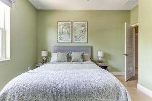 a bedroom with a large bed with green walls at Chic & Spacious 4 Bedroom 3 Full Bathrooms Retreat in West Tampa and Pvt Backyard in Tampa
