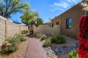 a house with a brick fence and a brick walkway at Casas de Suenos Old Town Historic Inn, Ascend Hotel Collection in Albuquerque