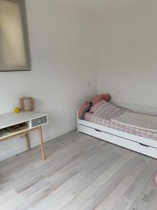 a bedroom with a bed and a table in it at Bright house 10m from Paris in Sèvres