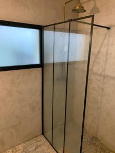 a glass container in a room with a window at Bright house 10m from Paris in Sèvres
