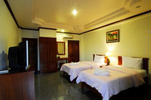 Voodi või voodid majutusasutuse Busyarin Hotel toas