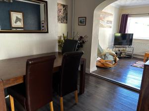a dining room with a table and chairs at Ortari@70 in Bishopston