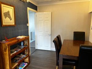 a room with a table and a table and a door at Ortari@70 in Bishopston