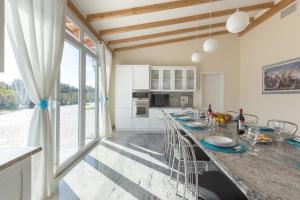 a kitchen with a long table with blue plates on it at Villa Vincenti by BarbarHouse in Ruffano