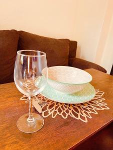 a table with a plate and a wine glass on it at City Comfort Suite Anviolhomes in Hannover