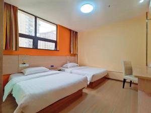 a bedroom with two beds and a desk and a window at 7 Days Inn Chongqing Beibei New District Light Rail Station in Huangjuezhen +156 photos