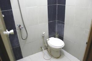 a bathroom with a toilet and a shower at OYO Life 2982 Griya Aisyah Residence 2 in Kedurus +19 photos