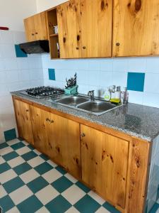 a kitchen with a sink and a counter top at Golden Dune View in Torre Dei Corsari