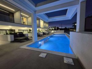 a swimming pool in the middle of a house at JD Studios Kalithea in Kallithea Halkidikis