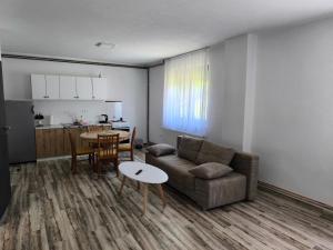 a living room with a couch and a table at House Mila in Korenica