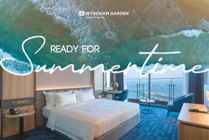 a hotel room with a bed and a sign saying ready for summerine at Wyndham Garden Legend Halong in Ha Long