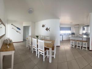 a kitchen and dining room with a table and chairs at Dana Bay Beach House in Mossel Bay