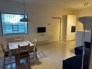 a kitchen and dining room with a table and chairs at casa villa degli ulivi in Colonnella