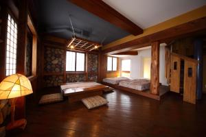 a bedroom with two beds and a table in it at Hotel Asyl Nara in Nara