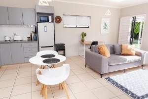 a living room with a couch and a table at Belle Rose Place in Meadowridge