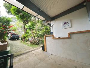 a garage door with a sign on the side of a building at Orchid Bed and Breakfast in Galicias
