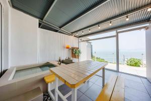 a dining room with a table and a view of the ocean at Yeosu Ekklesia Pool Villa N Jacuzzi in Yeosu