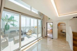 a living room with glass doors and a dining room at Yeosu Ekklesia Pool Villa N Jacuzzi in Yeosu +9 photos