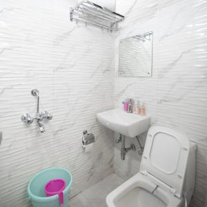 un bagno bianco con un water e un lavandino di Sona Nearby Park New Delhi Railway Station a Nuova Delhi