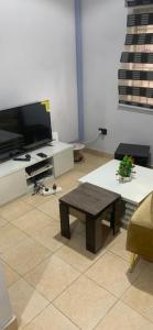 a living room with a coffee table and a flat screen tv at Reyna apartment in Lekki