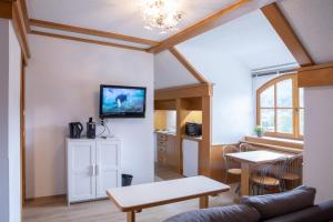 a living room with a couch and a table at Ferienwohnungen Gabriel in Keutschach am See