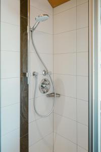 a shower with a shower head in a bathroom at Haus Margreth in Mellau