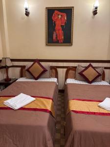 Postel nebo postele na pokoji v ubytování BI SAIGON Hotel - BUI VIEN WALKING STREET