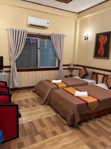 Postel nebo postele na pokoji v ubytování BI SAIGON Hotel - BUI VIEN WALKING STREET