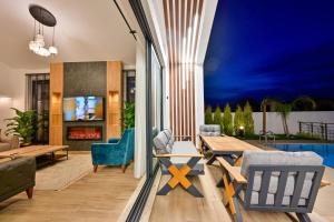 a living room with a table and chairs at Odella - Luxury Villa for 6 in Seydikemer Zorlar in Fethiye